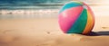 Tropical beach ball on sand, ocean summer holiday background colorful beach ball in sand