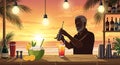 A tropical beach bar setting features a male bartender preparing a cocktail. The Royalty Free Stock Photo