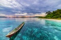 Tropical beach, caribbean sea, canoe floating on transparent turquoise water, remote Togean Islands Togian Islands, Sulawesi, In