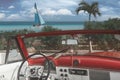 The tropical beach of Cayo Coco in Cuba with american classic car, palm trees on a summer day with turquoise water. Vacation