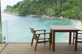 Tropical beach with chairs for relaxation on wooden terrace. Royalty Free Stock Photo