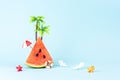 Tropical beach concept made with watermelon and sun umbrella. Creative minimal summer background Royalty Free Stock Photo