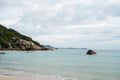 Tropical beach with a crystal blue water with a mountain in Thailand.