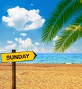 Tropical beach and direction board saying SUNDAY Royalty Free Stock Photo