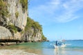 Tropical beach in El Nido, Palawan, with a boat man on a tipical Philippinos boat