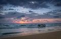 Tropical Beach with Empty Cage in the Sea at Sunset Royalty Free Stock Photo