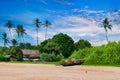 Tropical beach with exotic greenery, hut and old fishing boat. Sri Lanka Royalty Free Stock Photo