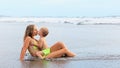 On tropical beach funny baby boy kiss young beautiful mother Royalty Free Stock Photo