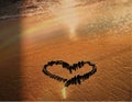 Tropical  beach and heart symbol on sand , palm  leaf shadow on  gold  sunset  light nature landscape  background Royalty Free Stock Photo