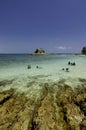 Tropical beach at Kapas Island, Malaysia. Wet Rock and crystal clear sea water with blue sky background Royalty Free Stock Photo