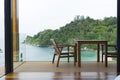 Tropical beach with chairs for relaxation on wooden terrace. Royalty Free Stock Photo