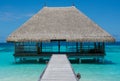 Tropical beach landscape with wooden bridge and house on the water at Maldives