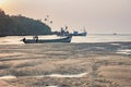 Tropical beach at low tide with fishing boats