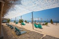 Tropical beach with palm trees and chairs Royalty Free Stock Photo