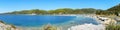 Tropical beach panorama with lush green mountains around the bay. Perfect place for wild camping with caravans and RV. Shallow