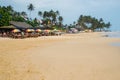 Tropical beach with people, coffee bar and umbrella Royalty Free Stock Photo