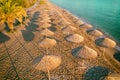 Tropical beach scenery with sun parasols and palm branches Royalty Free Stock Photo