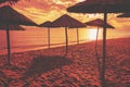 Tropical beach scenery with sun parasols. Straw sun umbrellas on the beach Royalty Free Stock Photo