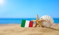 Tropical beach with seashells and Italy flag. Royalty Free Stock Photo