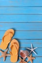 Tropical beach summer flip flops starfish background border vertical blue wood Royalty Free Stock Photo