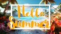 Hello Summer lettering on a tropical beach background with palms and flowers