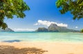 Tropical beach with lush green islands in the backgroud