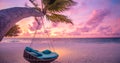 Tropical beach sunset landscape panorama, beach swing or hammock and sunset sky white sand and calm sea for beach banner Royalty Free Stock Photo