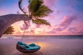 Tropical beach sunset landscape with beach swing or hammock and sunset sky white sand and calm sea for beach banner Royalty Free Stock Photo