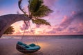 Tropical sunset beach sky background as exotic summer landscape beach swing or hammock and white sand and calm sea beach banner. Royalty Free Stock Photo