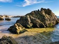 Tropical beach at sunset - nature background. Stones balance on beach, sunrise shot. Rocky coastal landscape scene at shore of Royalty Free Stock Photo