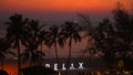 Tropical beach sunset with silhouette of