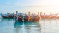 Tropical beach, Traditional long tail boats with golden sunset, Andaman Sea, Thailand.Tropical vacation holiday tourism beach conc Royalty Free Stock Photo