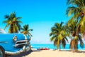 The tropical beach of Varadero in Cuba with american classic car, sailboats and palm trees on a summer day with turquoise water. Royalty Free Stock Photo