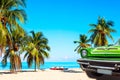 The tropical beach of Varadero in Cuba with green american classic car, sailboats and palm trees on a summer day with turquoise Royalty Free Stock Photo