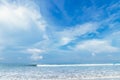 Tropical beach view. Calm and relaxing empty beach scene, blue sky and white sand. Tranquil nature concept. Bali. Royalty Free Stock Photo