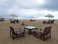 Tropical beach view with relax chairs and umbrellas. Beach landscape with white sand scenery. Royalty Free Stock Photo