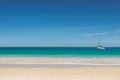 Tropical beach white sailing yacht in the sea.