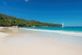 Tropical beach white sailing yacht in the turquoise sea.