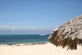 Tropical beach with white sand, blu sea, blu sky and sailboats Royalty Free Stock Photo