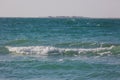 Tropical beach white sand, blue clear ocean water. sea foam on the beach on a sunny day. sea waves on the shore. surf breaking on Royalty Free Stock Photo