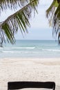 Tropical beach white sand view of the ocean landscape sunny paradise rest under the shadow of palm trees Royalty Free Stock Photo