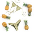 Tropical beauty concept. Pineapples fruits and swimwear on white background. Flat lay, top view