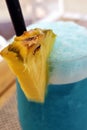 Tropical Bliss: Blue Cocktail with Pineapple Garnish