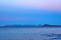 Tropical blue sea and blue sky with mountains on a horizon as a natural background. Royalty Free Stock Photo