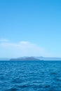 Tropical blue sea and blue sky with mountains on a horizon as a natural background. Royalty Free Stock Photo