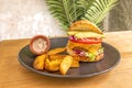 Tropical burger with ripe avocados, tomato and red onion, melted cheddar cheese and a good piece of seasoned minced beef and