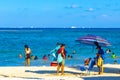 Tropical Caribbean beach people parasols fun Playa del Carmen Mexico