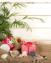 Tropical Christmas Still Life with gifts and sea shells against white shiplap background with copy space Royalty Free Stock Photo