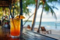 Tropical cocktail on a beach cafe table. Refreshing fruit cocktail on luxury tropical beach resort. Party, summer vacations,