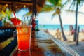 Tropical cocktail on a beach cafe table. Refreshing fruit cocktail on luxury tropical beach resort. Party, summer vacations,